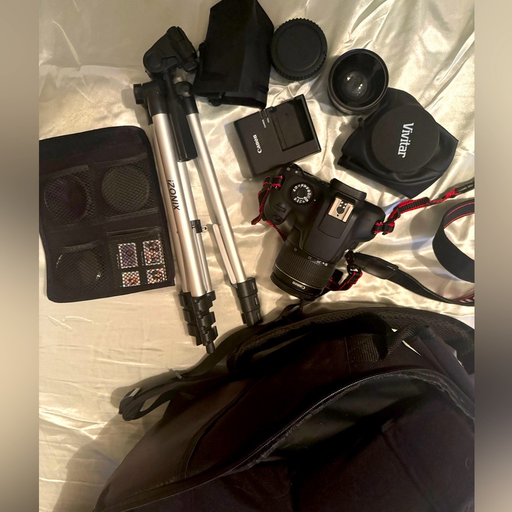 CANON EOS Rebel t100 with 18-55mm lens and another lens.